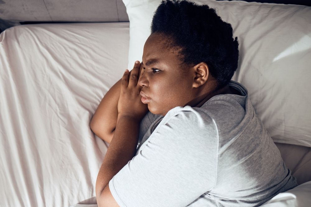 black women in bed lying down cant sleep